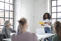 Woman speaking in front of group